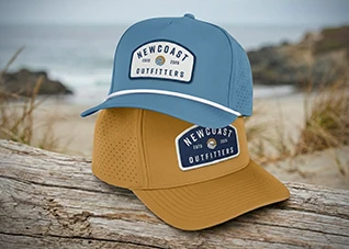 Two caps with stacked on top of eachother, one is a blue-tinged teal, the other is an orange tan