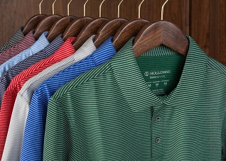 A variety of different colored polo shirts on a coat-rack